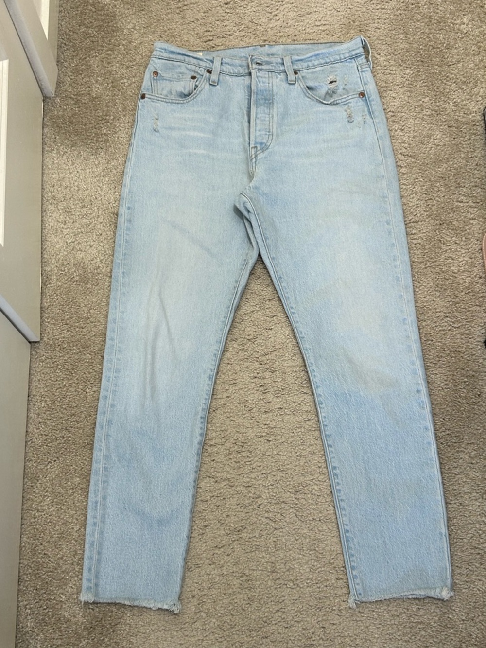 Levi's 501 Light Blue Denim Jeans with Distressed Pockets and Raw Cropped Hem